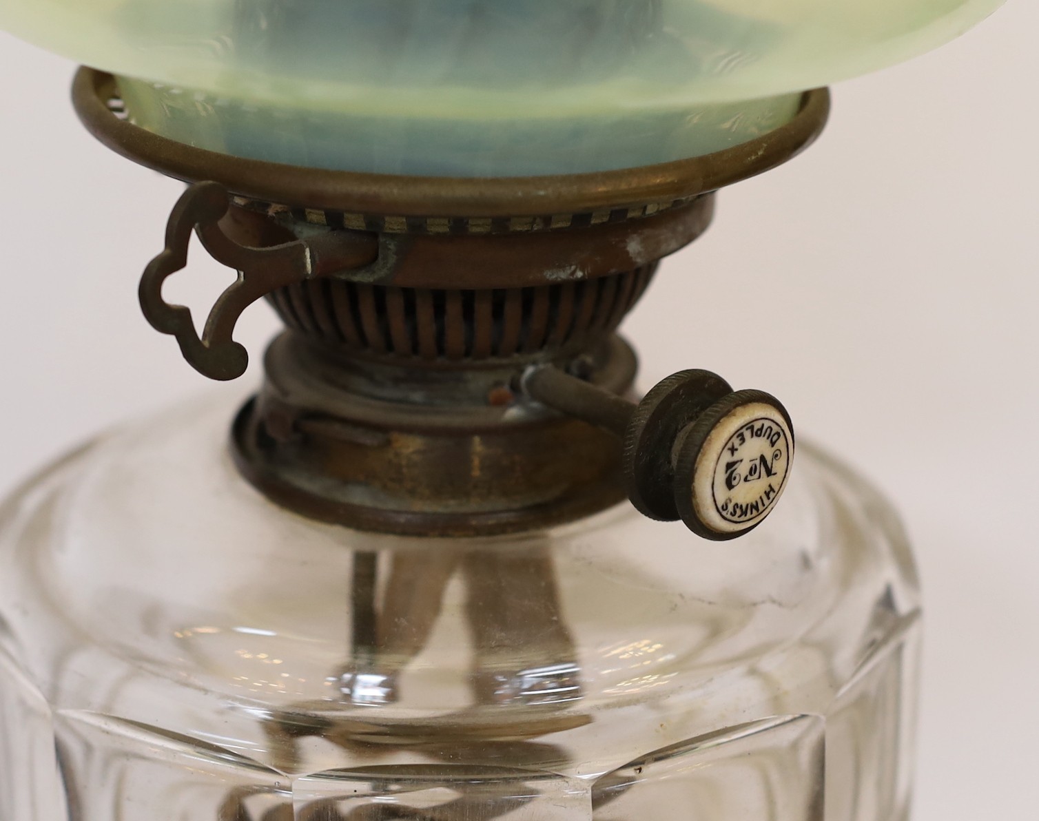 An Edwardian brass oil lamp with cut glass reservoir, Hinks No2 duplex mechanism, Vaseline shade and flue, height overall 67cm
